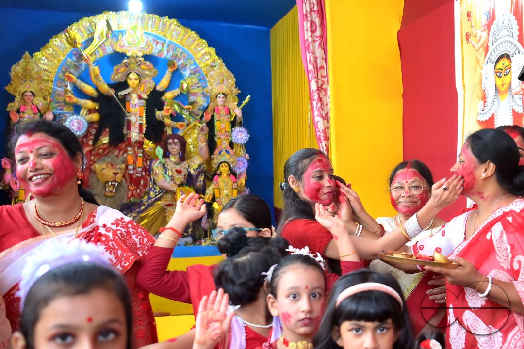 Children and married women are dancing, and the women smear each other with vermillion during a ritual called the vermillion game, or "Sindur Khela," on the last day of the Durga Puja festival in Agartala, Tripura, India.