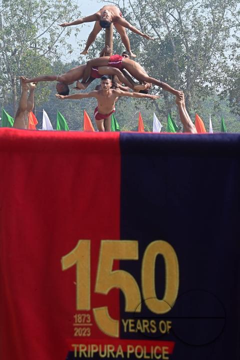 Police officials perform Mallakhamb, a traditional sport, in celebration of 150 years of Tripura Police Week at the stadium of A.D