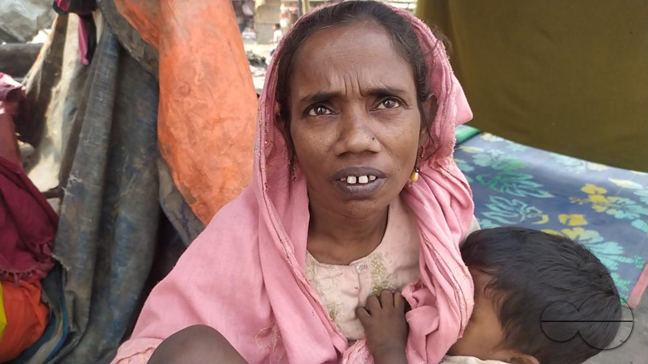 Portrait of a mother feeding a child at the Balukhali refugee camp