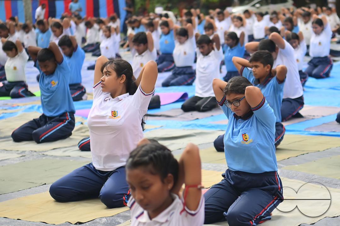 NCC cadets and officials perform yoga during 10th International Day of Yoga Day at BBM College Ground in Agartala