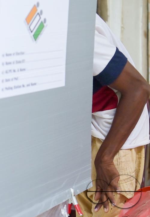 A differently abled boy casting his postal ballot vote at his house in front of the team of election officials and security personnel in Agartala