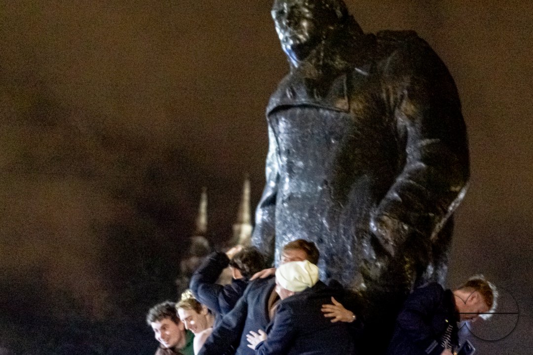 Group of Men celebrating Brexit Night on the Churchill Statue