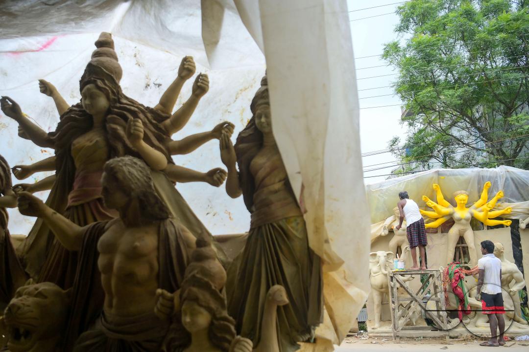 Idol makers adding finishing touches to an idol of the Mother Goddess Durga in a studio, ahead of the Durga Puja festival in Agartala, Tripura, India.
