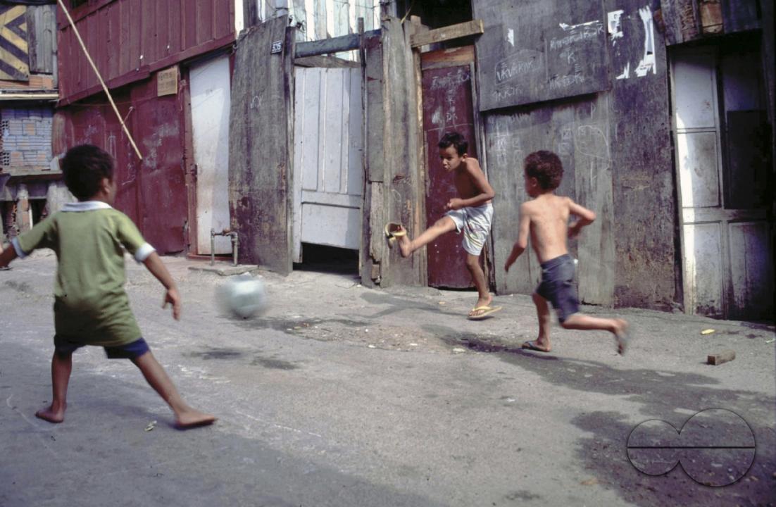 CHILDREN PLAYING FOOTBALL IN THE SHANTY TOWNS OF SANTOS, BRAZIL. Photo  Julio Etchart