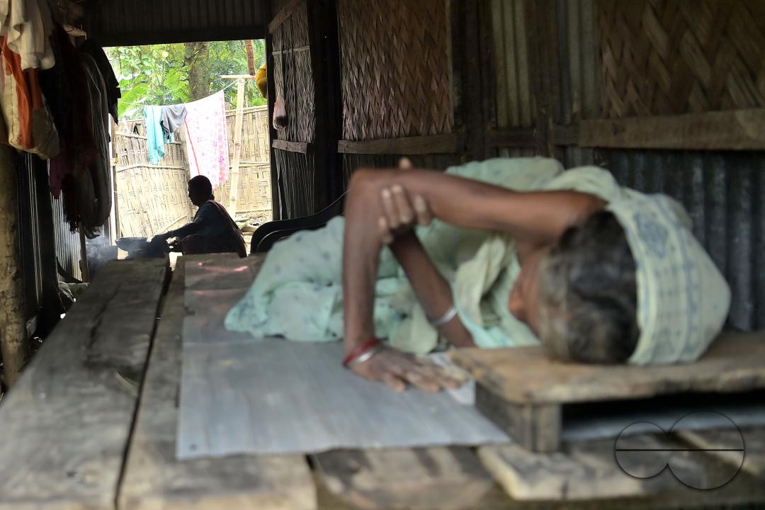 A lady is cooking in her home immersed in flooded water, outskirts of Amarpur city, 82km away from Agartala
