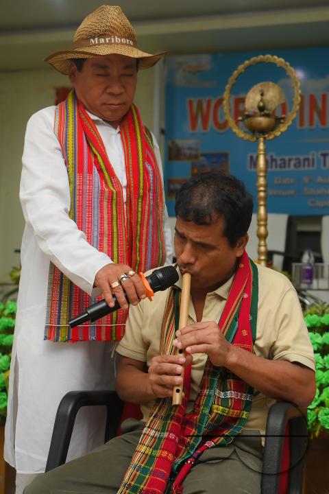 An indigenous blind musician playing the flute on the occasion of World Indigenous Day at an auditorium in Agartala