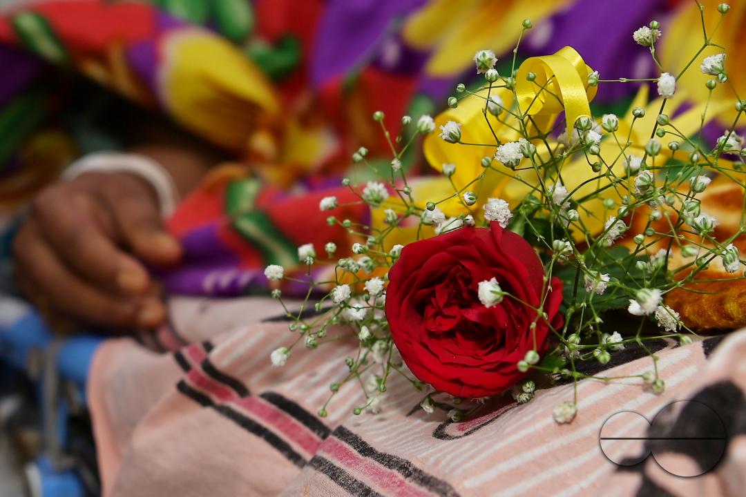 A rose and fruits are distributed to a patient by doctors and health workers during the celebration of World Kindness Day in the dialysis ward at IGM (Indira Gandhi Memorial) Hospital in Agartala