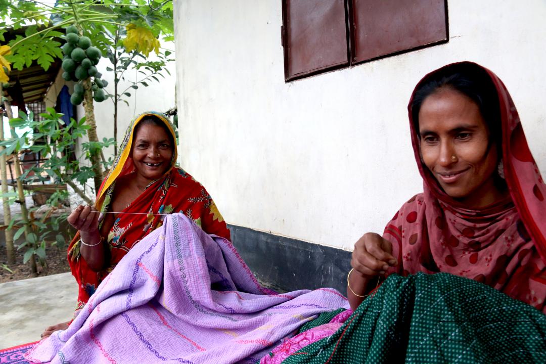 Rural Bangladeshi women sewing and embroidering bed sheets, pillow cases, rugs, table cloths and other household items which is their livelihood