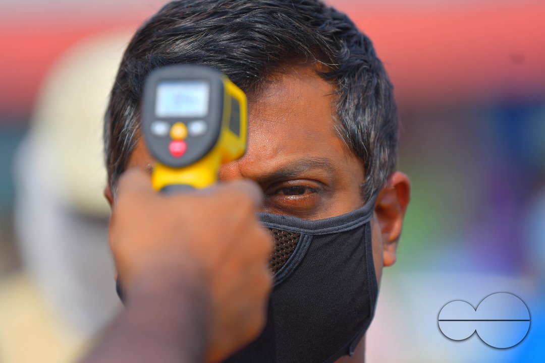 The health workers are applying infrared thermometer to check the temperatures