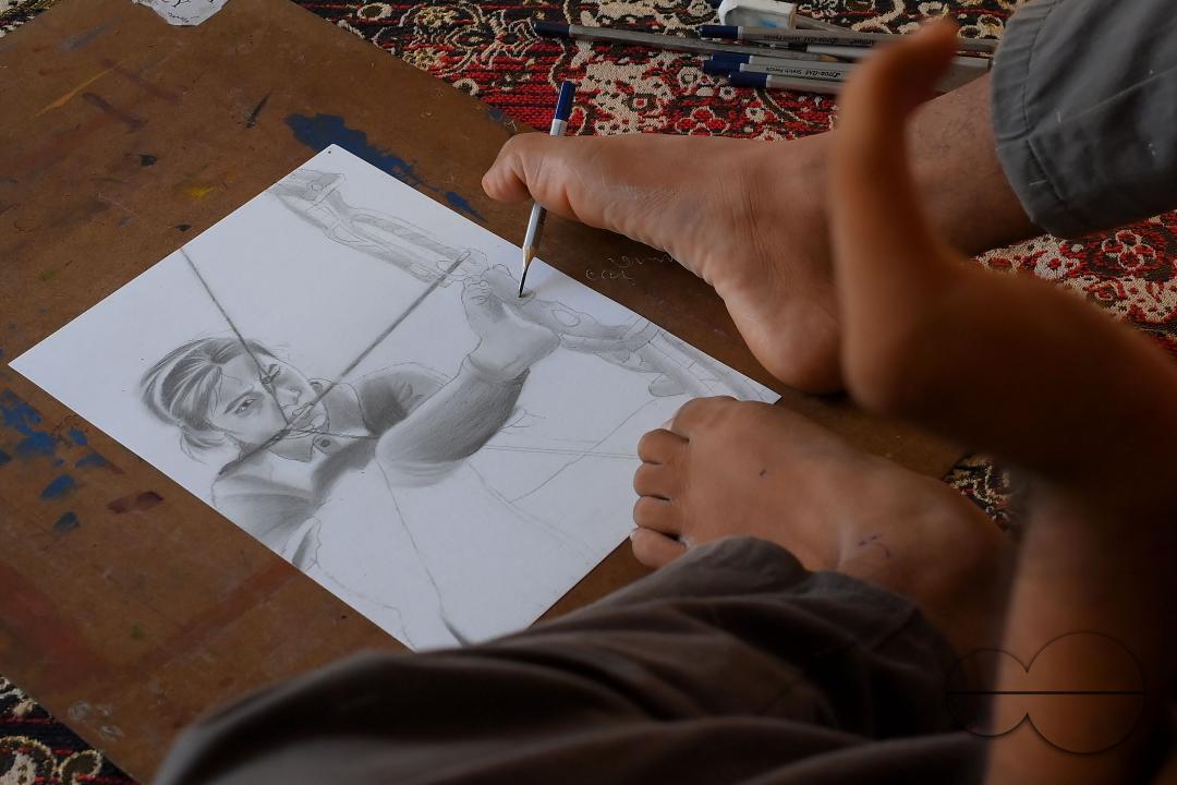 A 23-year-old differently abled artist Pralay Dey, is pursuing his bachelorâs degree in psychology from Tripura Central University