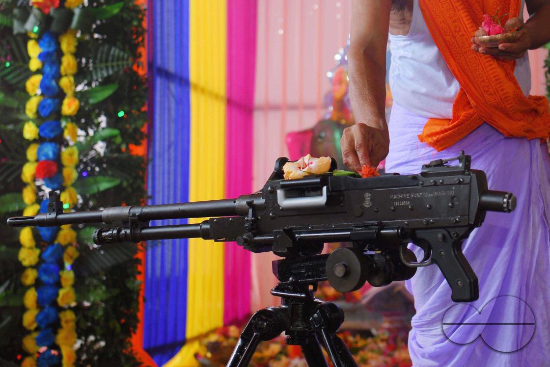 A priest performs worship of arms on Vishwakarma Puja in a TSR (Tripura State Rifles) camp on the outskirts of Agartala