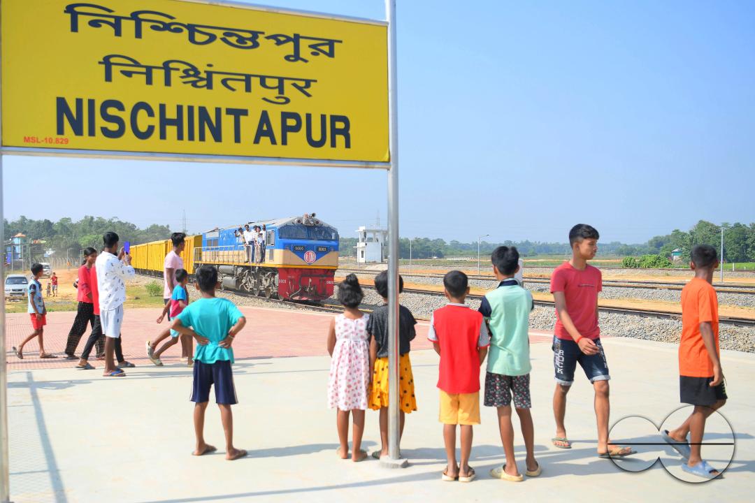 Indian people looking at a trial train and taking photographs, which is crossing the Indo-Bangladesh border
