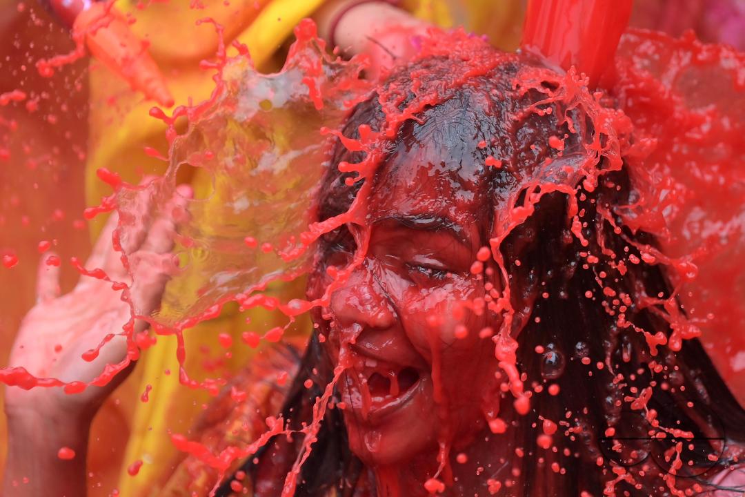 Indian girls adorned with 'Gulal' or coloured powder during the Hindu spring festival 'Holi', the festival of colour in Agartala
