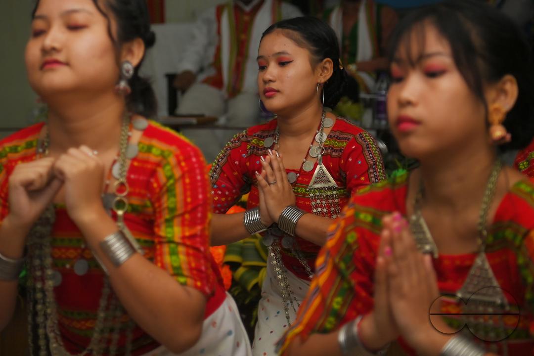 Indigenous girls perform traditional dances on the occasion of World Indigenous Day in an auditorium at Agartala