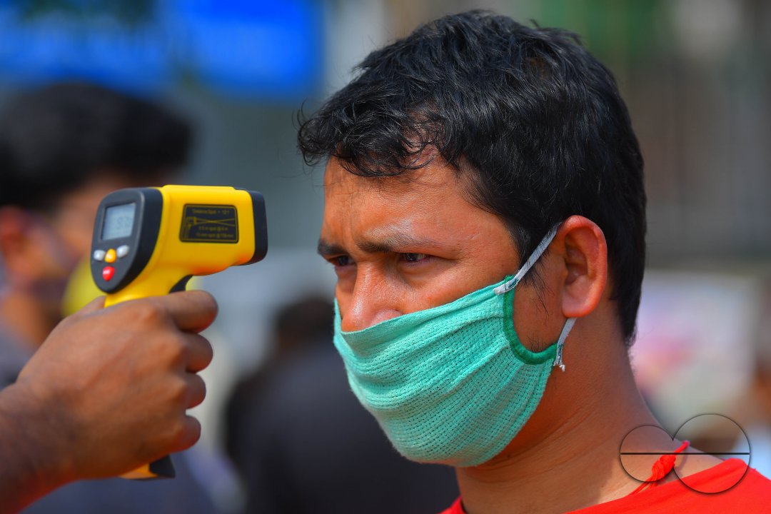 The health workers are applying infrared thermometer to check the temperatures