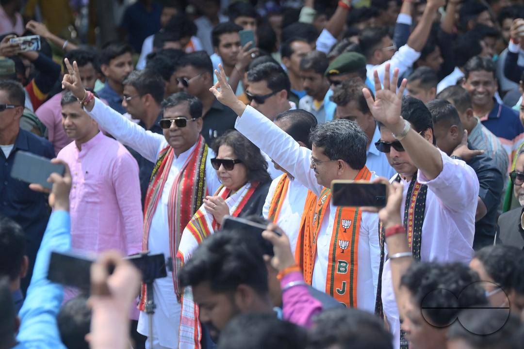 BJP supporters seen in a rally with Tripura Chief Minister Manik Saha, former CM and BJP candidate Biplab Kumar Deb, and Kriti Singh along with other leaders during an election campaign rally in support of Lok Sabha candidates at Agartala