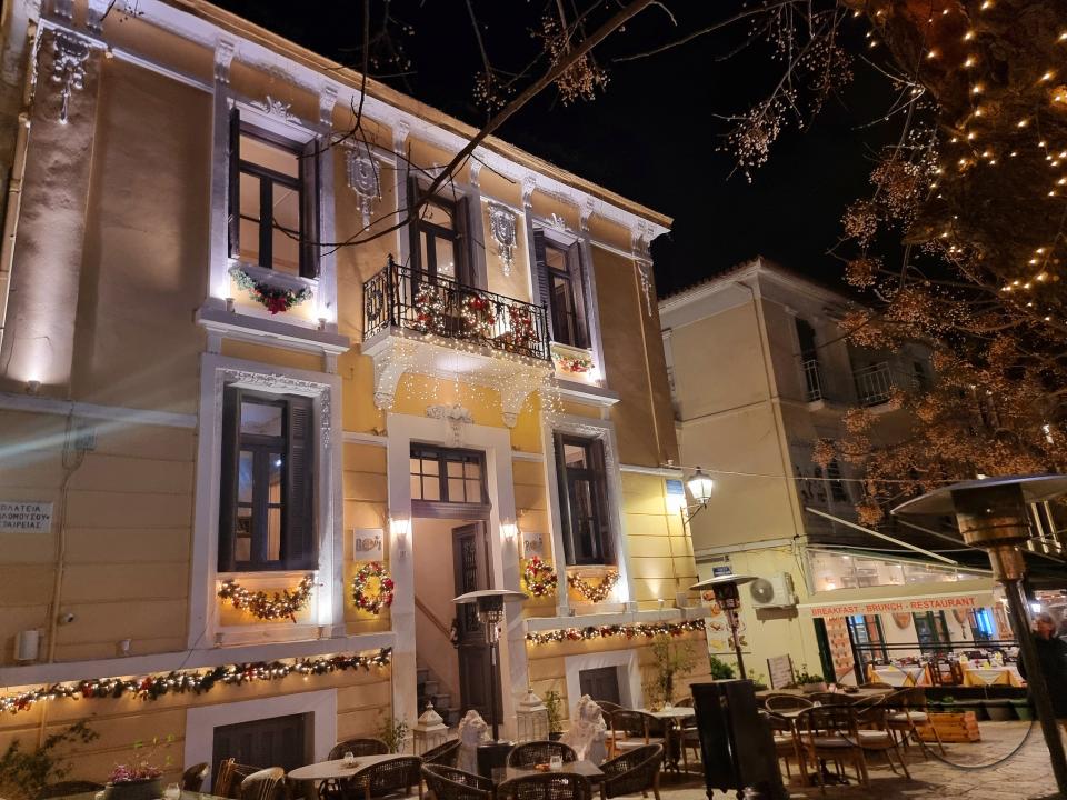 Restaurants abound in the central square of Platonas, Athens, welcoming clients at night