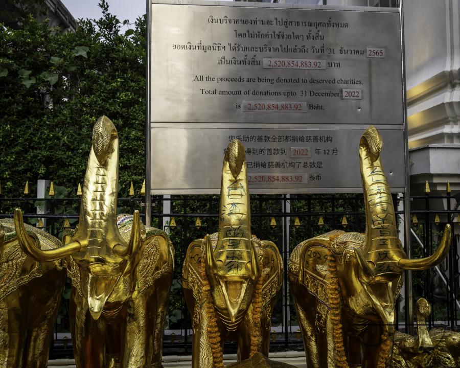A view of the ceramic elephants which were purchased by Thai and tourists as an offering with a sign indicating the amount of donations, at the Erawan Shrine, in downtown Bangkok