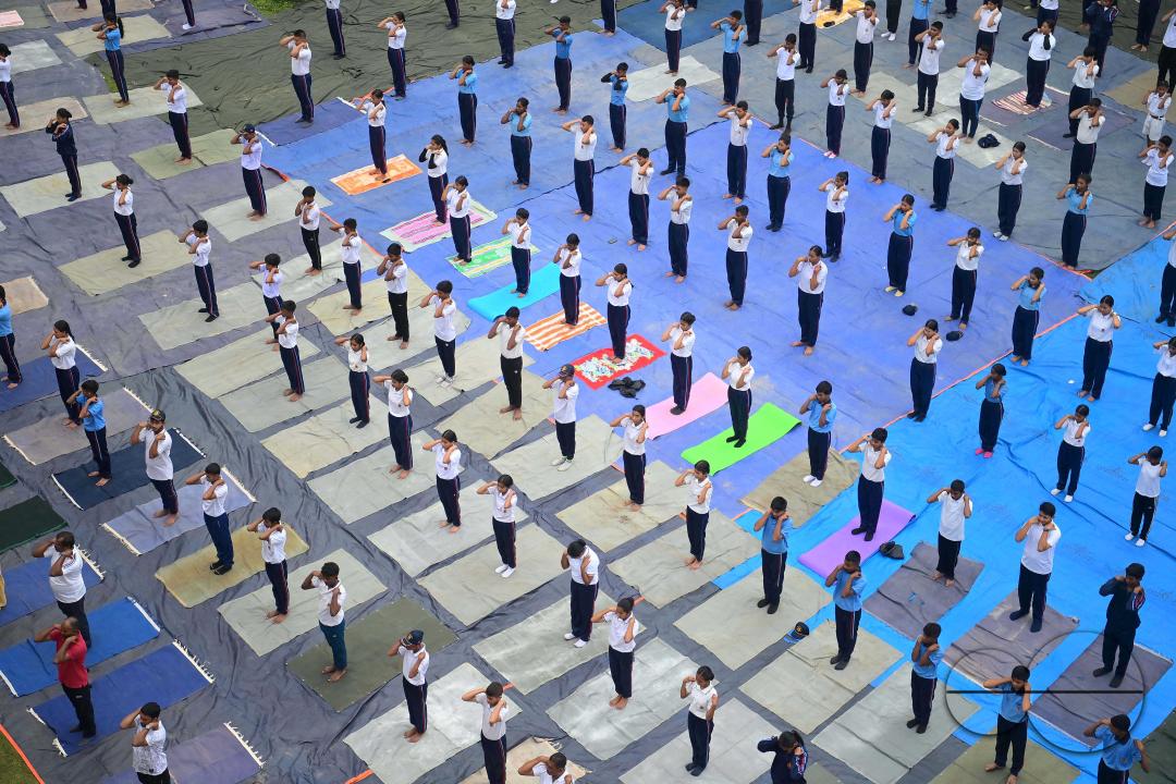 NCC cadets and officials perform yoga during 10th International Day of Yoga Day at BBM College Ground in Agartala
