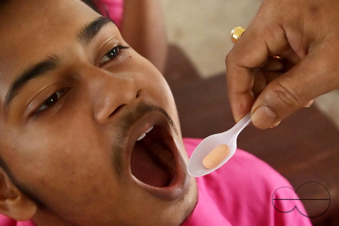 A student of Netaji Subhash Vidyaniketan High School is taking a deworming tablet during the special program "Mukhyamantri Sustho Shoishob, Sustho Kaishore Abhiyan (MSSSKA 7.0)" in Agartala