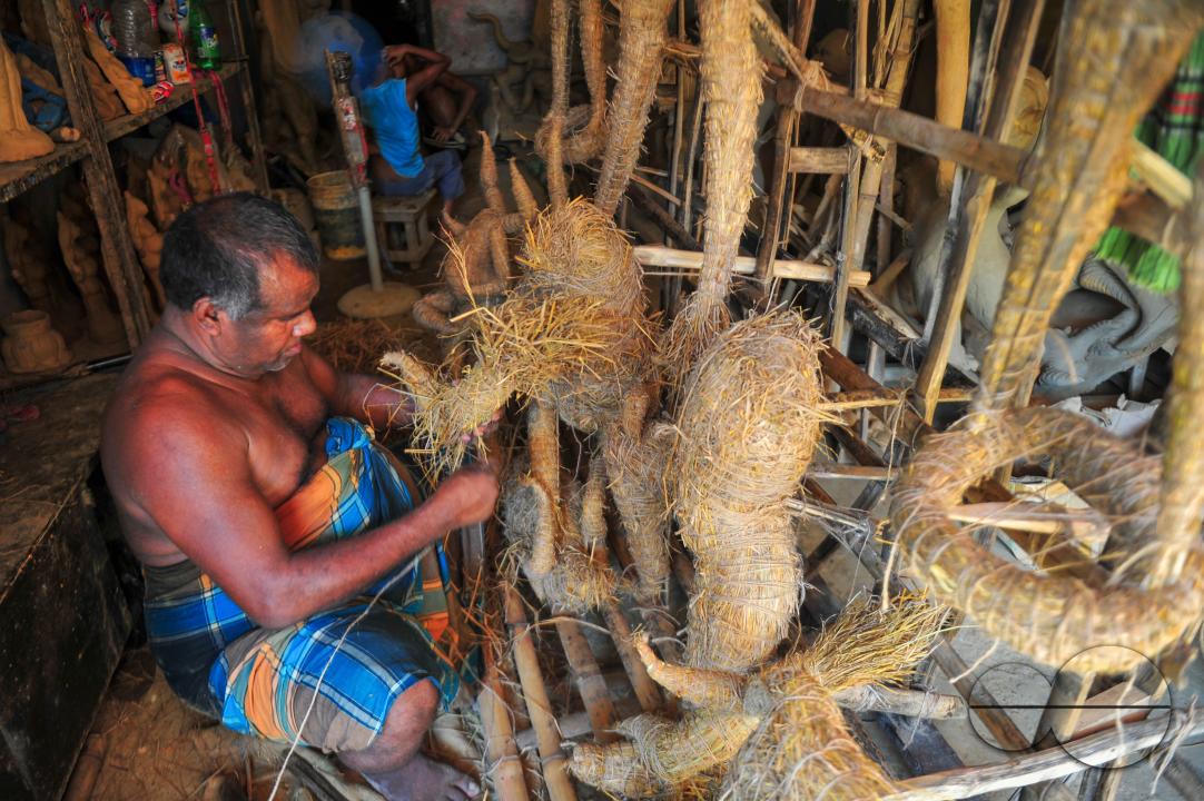 Nondi Pal, an idol artist is working on structures of Hindu Deity in preparation for the upcoming Durga Puja Festival 2023