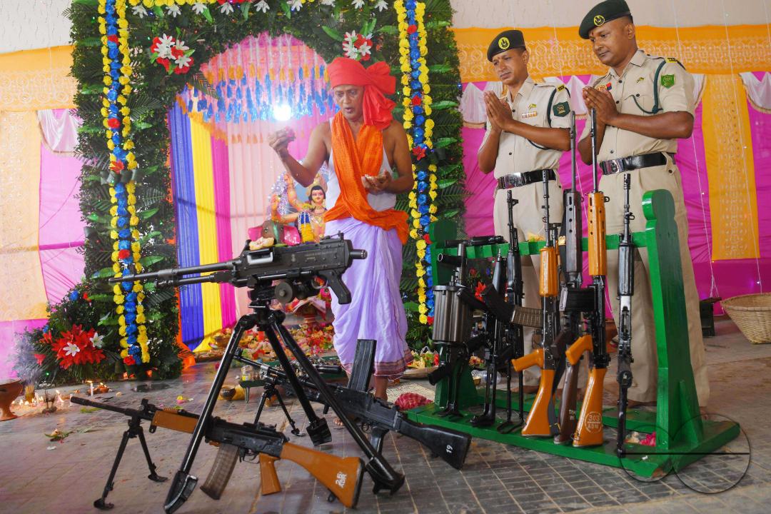 A priest performs worship of arms on Vishwakarma Puja in a TSR (Tripura State Rifles) camp on the outskirts of Agartala