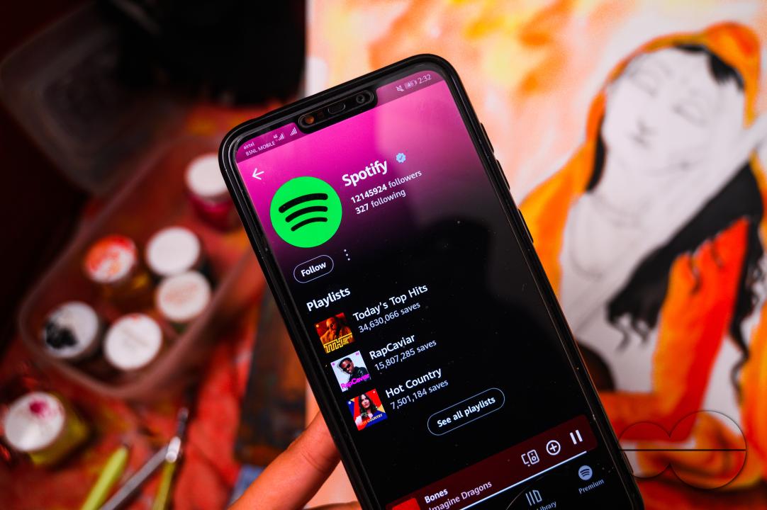 A girl draws a picture of "Mirabai" (16th-century Hindu mystic poet and devotee of Krishna), while listening to music on the Spotify app