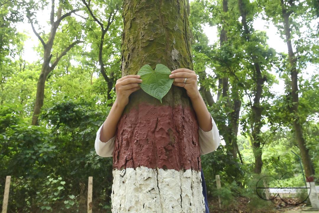 NSS (National Service Scheme) volunteers and school students of Netaji Subhas Vidyaniketan hug trees on the eve of World Nature Conservation Day