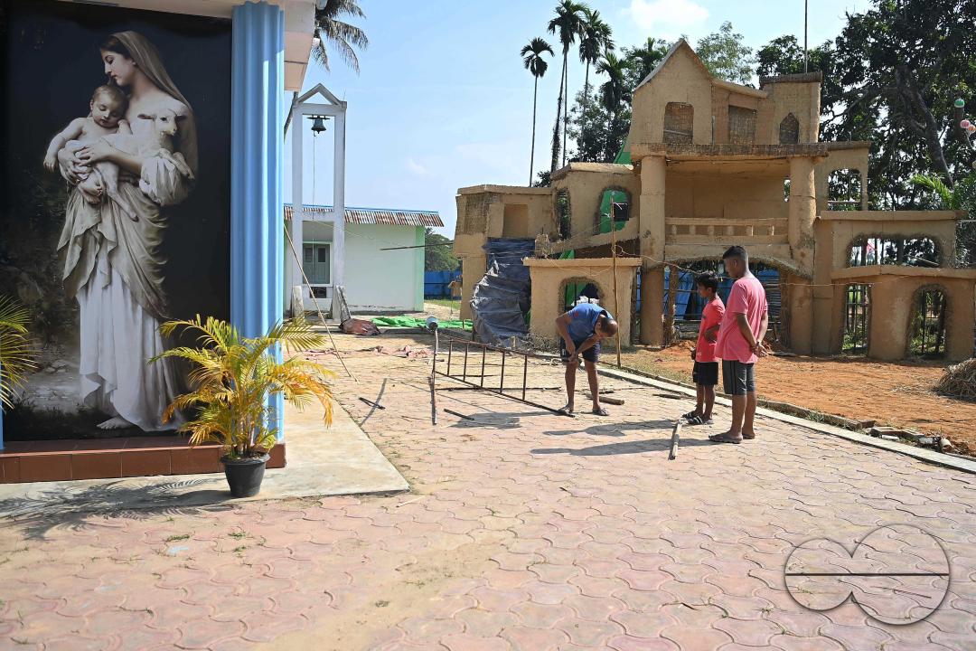 People decorate a church in preparation for Christmas Day at Mariam Church, Agartala