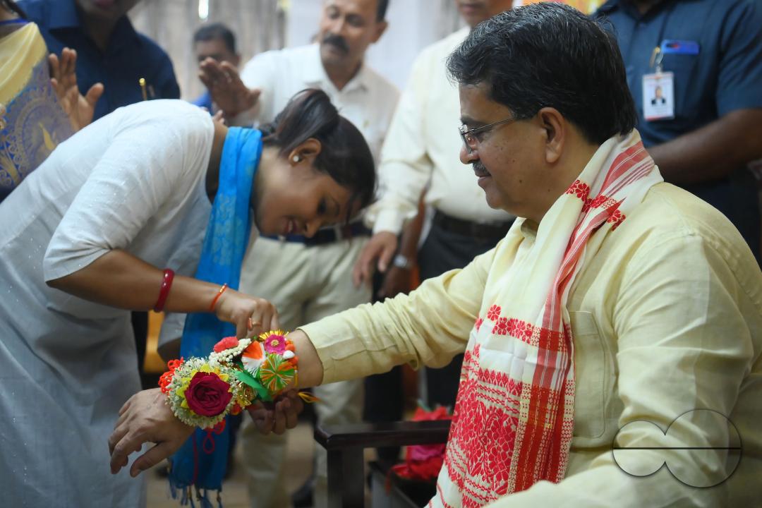 A lady tying rakhi and doing other rituals to Tripura CM Professor Dr
