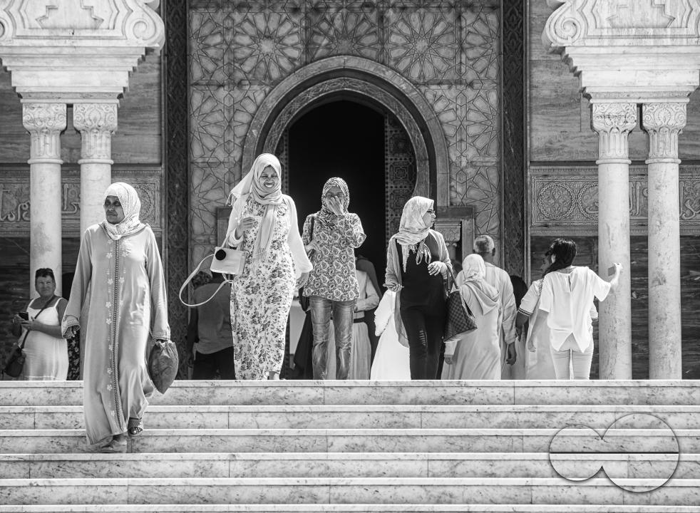 Tourists exploring the historic site of Hassan Tower