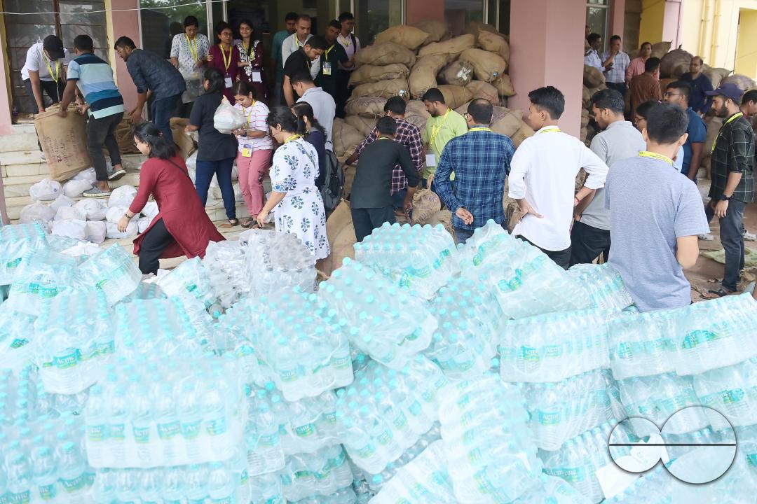 Government officials and workers are preparing food packets to be distributed by NDRF (National Disaster Response Force) personnel from helicopters to flood victims in different parts of Tripura