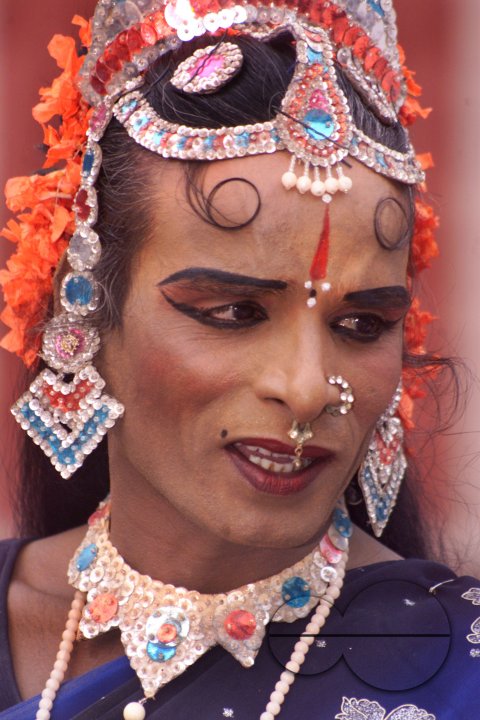 A South Indian male dancer dressed like a woman smiles during a stage show at a dance festival in Kolkata, India
