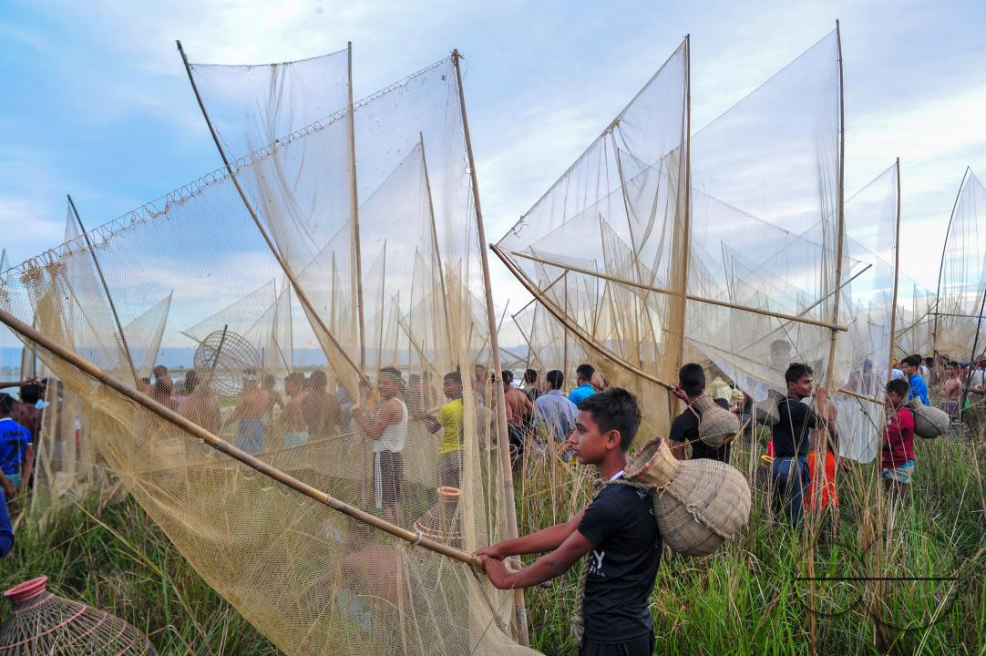 Rural people armed with Bamboo fish traps and nets take part in celebrating a 200-year winter fishing festival at the jofra beel of gasbari union of Kanaighat upazila of Sylhet, Bangladesh.