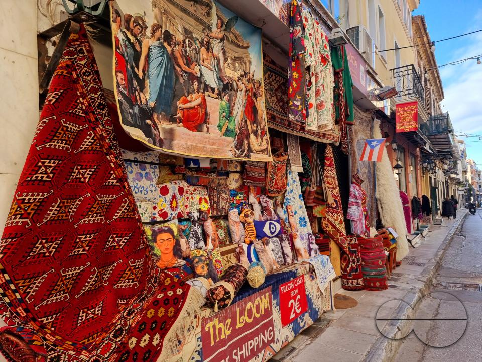 Artefacts including temple replicas, ships, carpets, and local produce are displayed in the old quarters of Athens