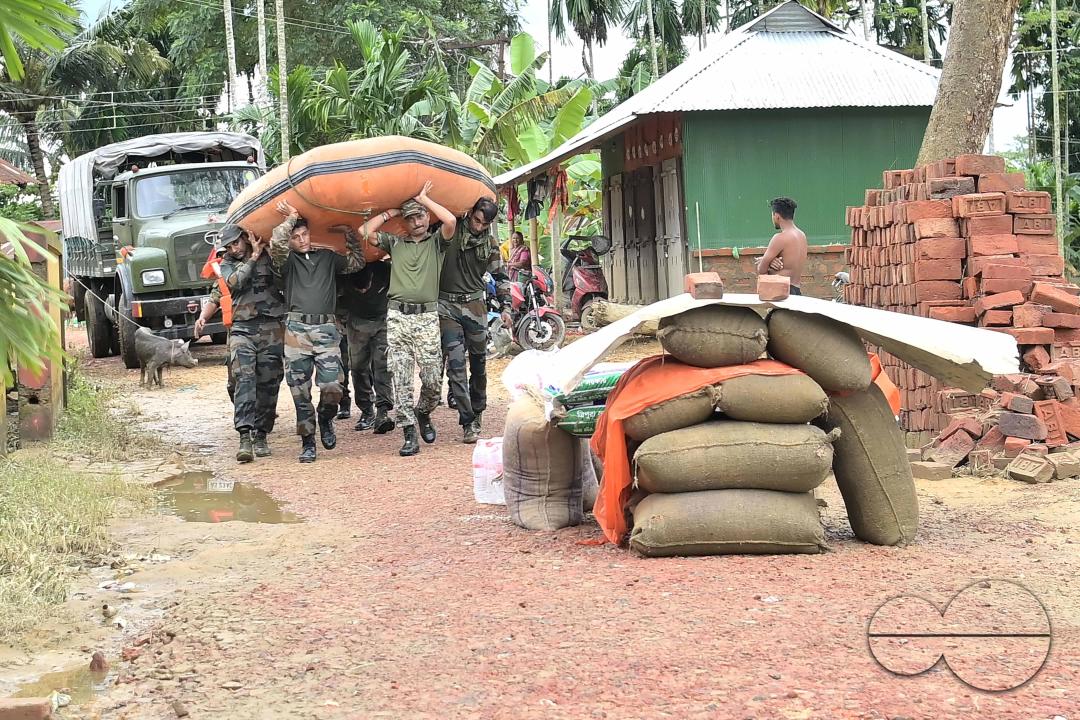 Assam Rifles personnel are carrying a boat to distribute food items to relief camps in different areas of Amarpur city which is immersed by flooded water, 82km away from Agartala