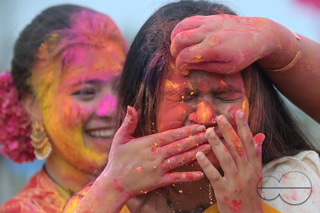 Indian girls adorned with 'Gulal' or coloured powder during the Hindu spring festival 'Holi', the festival of colour in Agartala