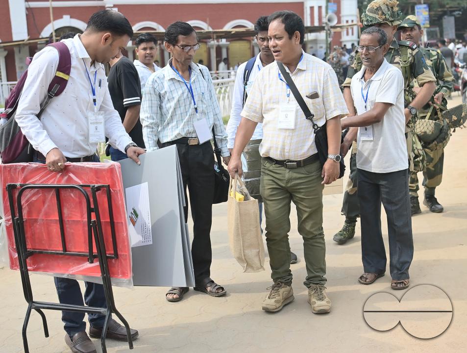 Election officials are coming out from the center with security personnel as they prepare to go door to door to collect votes