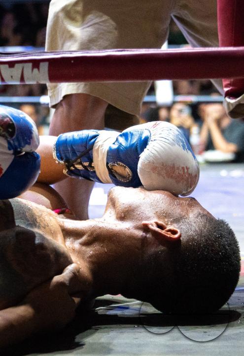 The Thai boxer Petch Si Nel is seen putting his glove on his face after a knockout, during the Muay Thai Fights, on Koh Chang Island, Thailand.