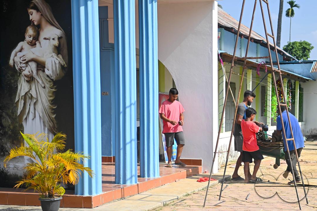 People decorate a church in preparation for Christmas Day at Mariam Church, Agartala
