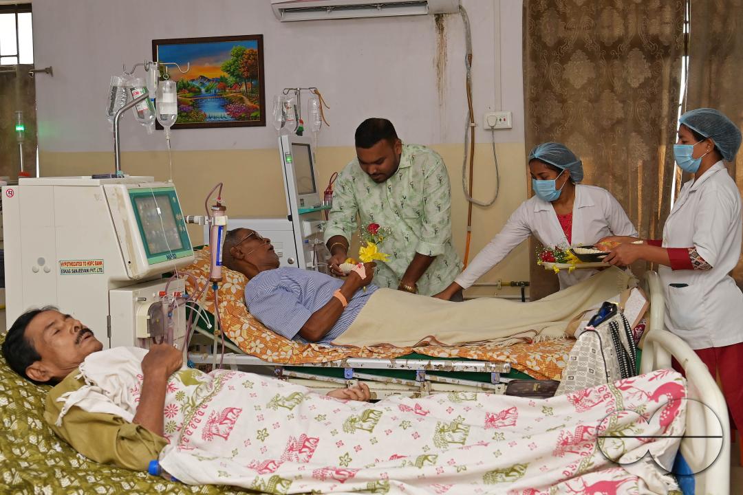 Doctors, along with health workers, distribute roses and fruits during the celebration of World Kindness Day in the dialysis ward at IGM (Indira Gandhi Memorial) Hospital in Agartala