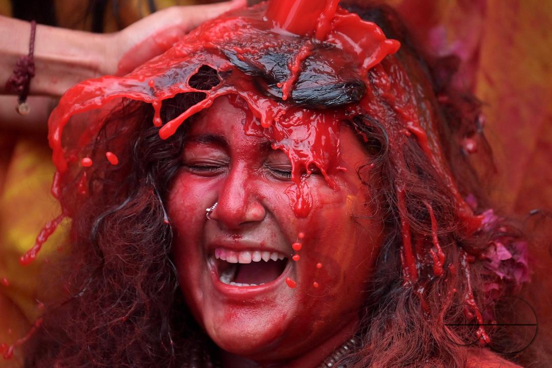 Indian girls adorned with 'Gulal' or coloured powder during the Hindu spring festival 'Holi', the festival of colour in Agartala