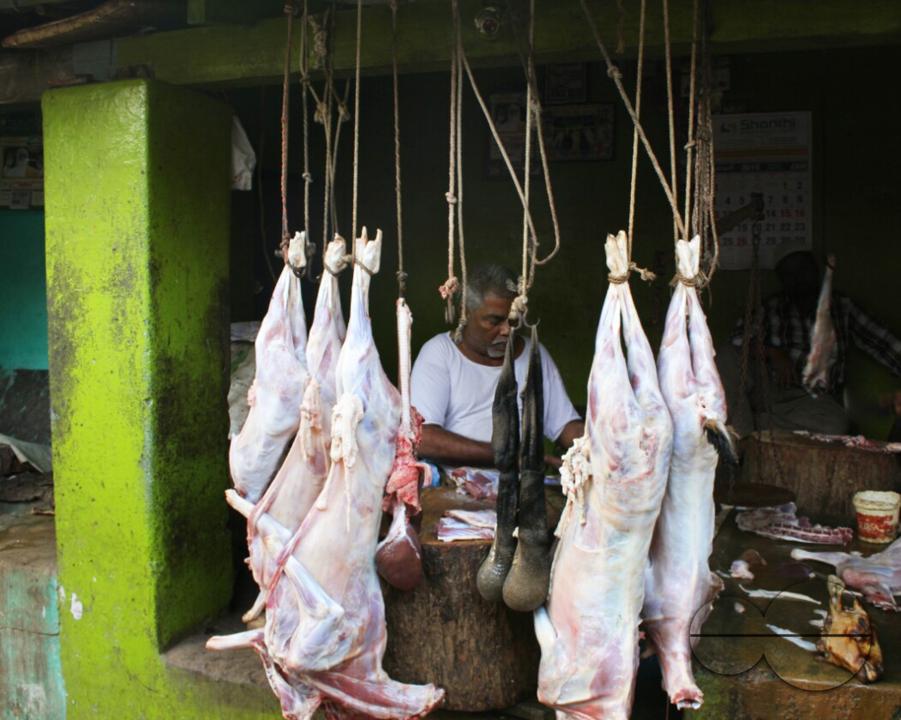 A man selling beef at a beef market at a rural village