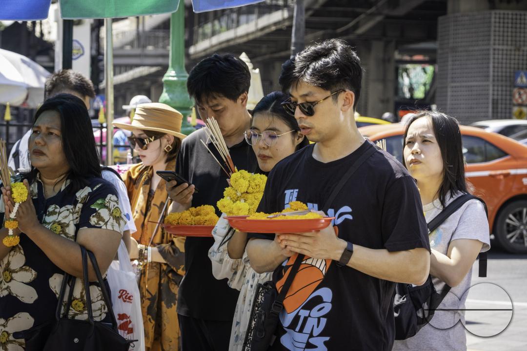 In downtown Bangkok, at the Erawan Shrine, Thai locals and tourists come together in prayer