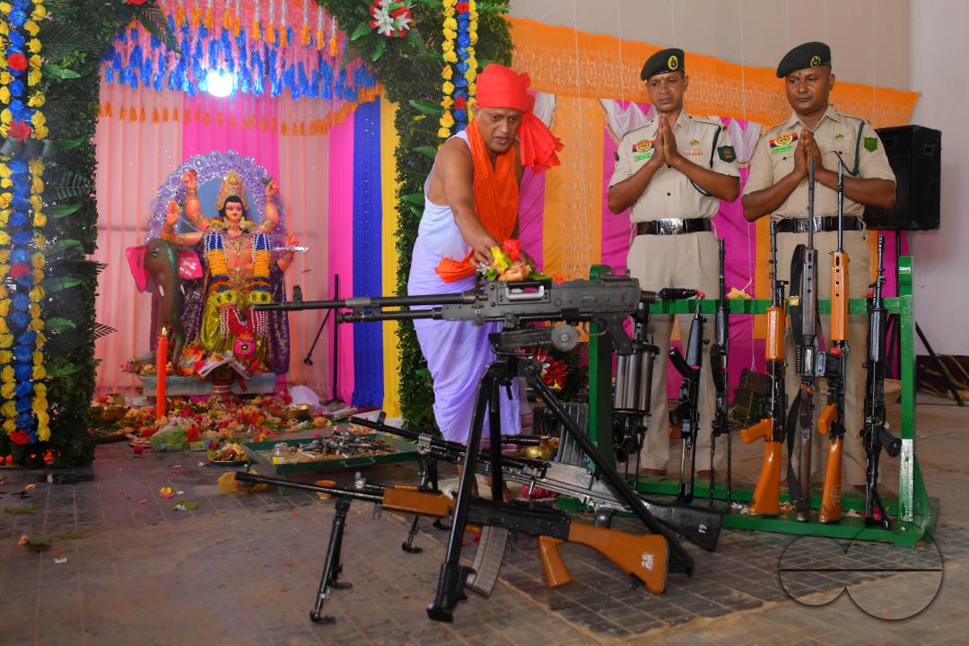 A priest performs worship of arms on Vishwakarma Puja in a TSR (Tripura State Rifles) camp on the outskirts of Agartala
