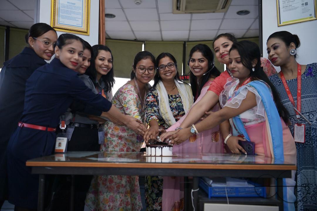 Air traffic controllers, air hostesses, and cabin crew are cutting cake to celebrate International Women's Day at Agartala airport's ATCT Tower in Tripura, India