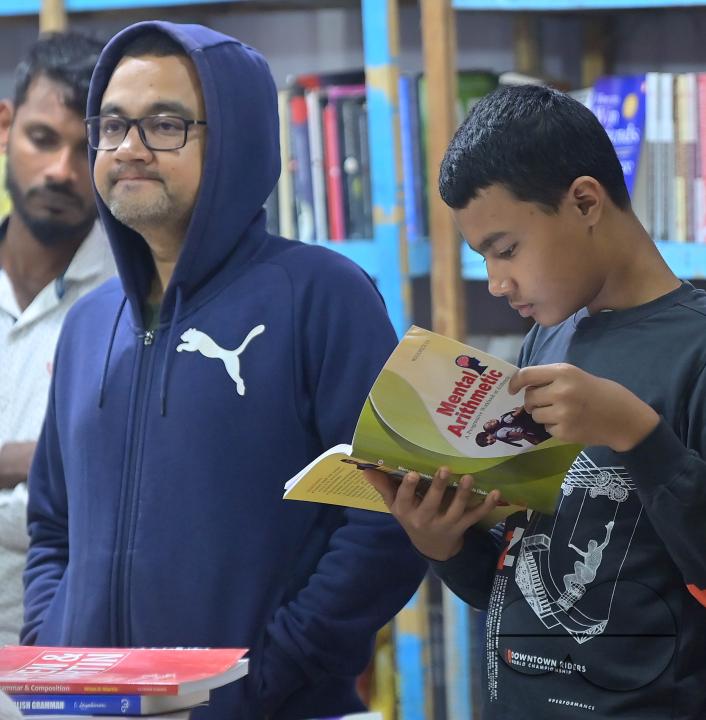 People looking at books in a book stall at the 42nd Agartala Book fair International Fair Ground, Hapania at Agartala