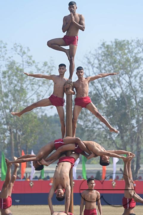 Police officials perform Mallakhamb, a traditional sport, in celebration of 150 years of Tripura Police Week at the stadium of A.D