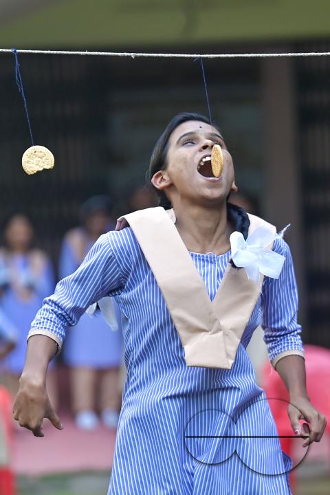 A student at the Institute for Visually Handicapped is participating in a 'Biscuit Race' during the 'Children's Day' celebration at the institute's campus in Narsingarh, in Agartala