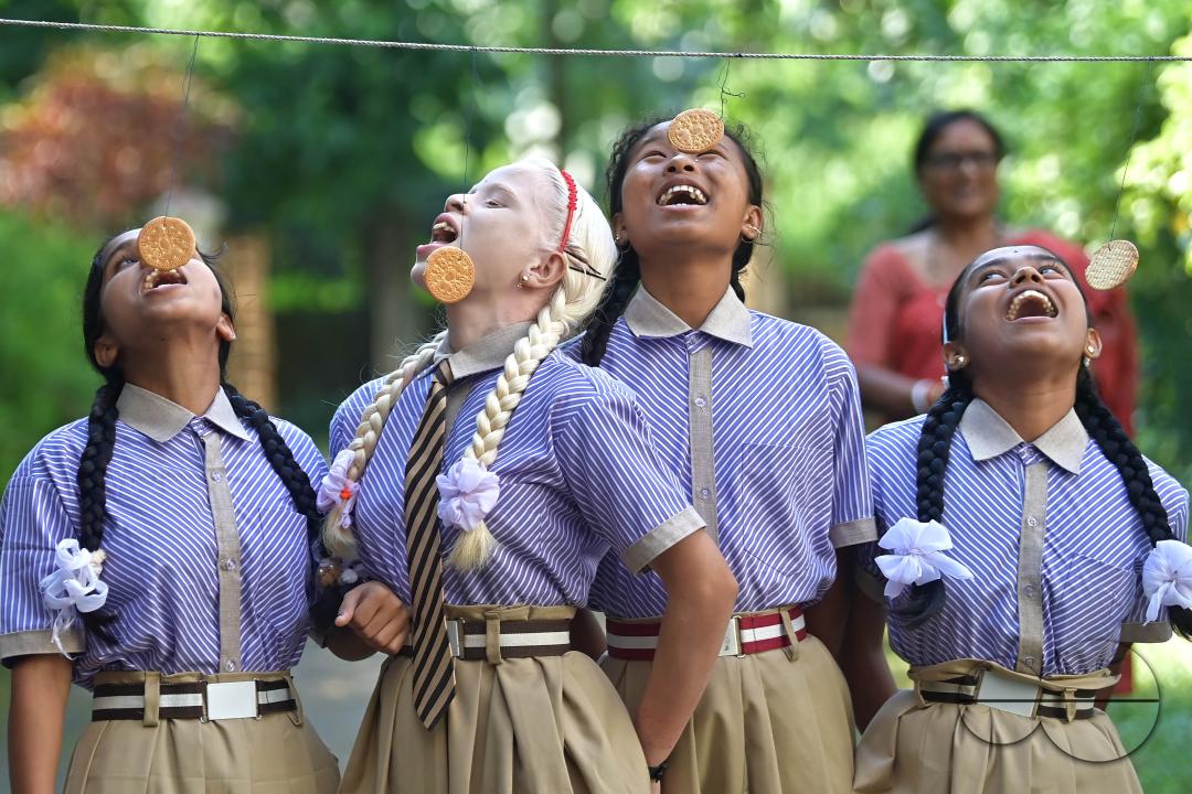 Students at the Institute for Visually Handicapped are participating in a 'Biscuit Race' during the 'Children's Day' celebration at the institute's campus in Narsingarh, in Agartala